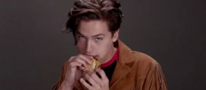 un garçon mange un burger