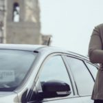 Un homme devant une voiture Chauffeur Privé