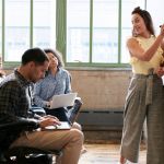 une femme forme ses collègues en petit groupe