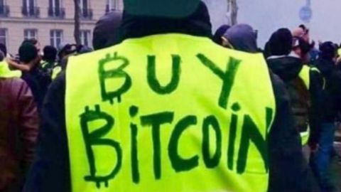 un gilet jaune avec l'inscrpition buy bitcoin