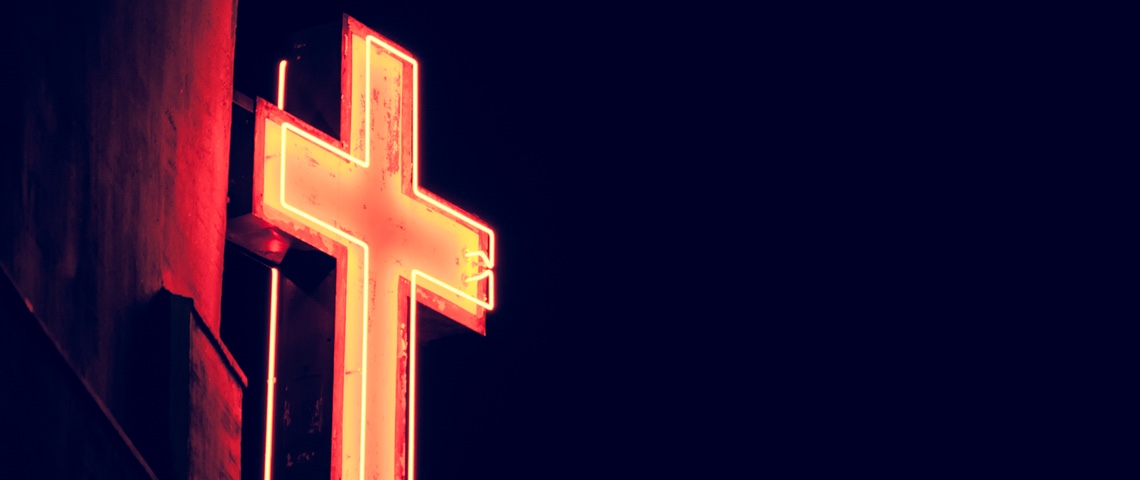 crypto-monnaie religion Néon en forme de croix chrétienne illuminé dans la nuit.