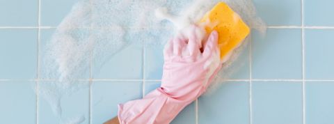 Une main passe l'éponge sur de la faïence