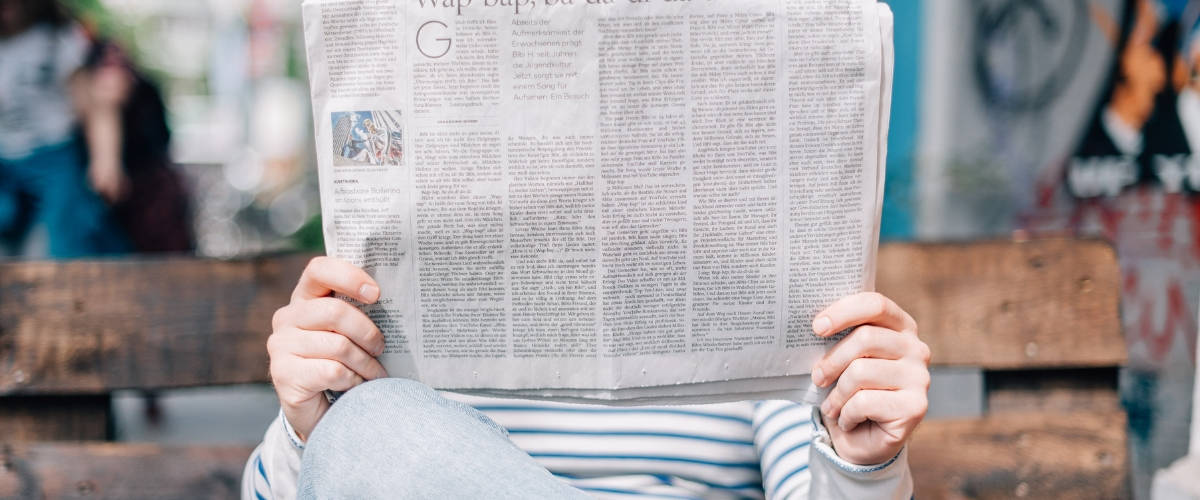 Streetpress lance sa campagne de crowdfunding Homme sur un banc lisant un journal