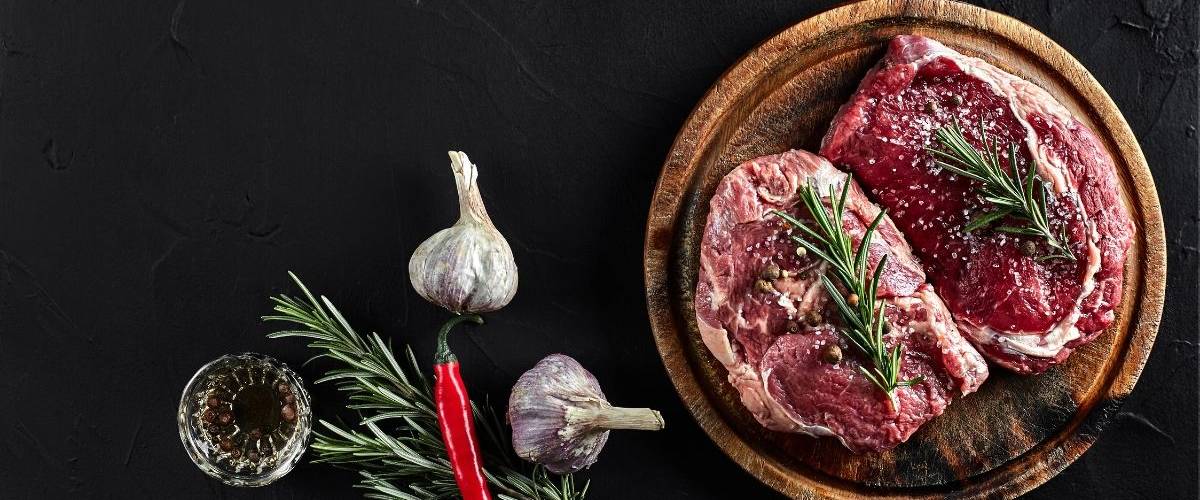 Le marché de la viande végétale pourrait atteindre les 140 milliards de dollars Deux morceaux de viande de boeuf placé sur une planche, sur une table en ardoise