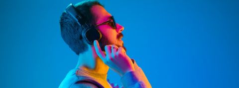 Sybel veut vous rendre accroc aux fictions sonores un homme portant des moustache vue de profil en train de mettre un casque sur les oreilles.