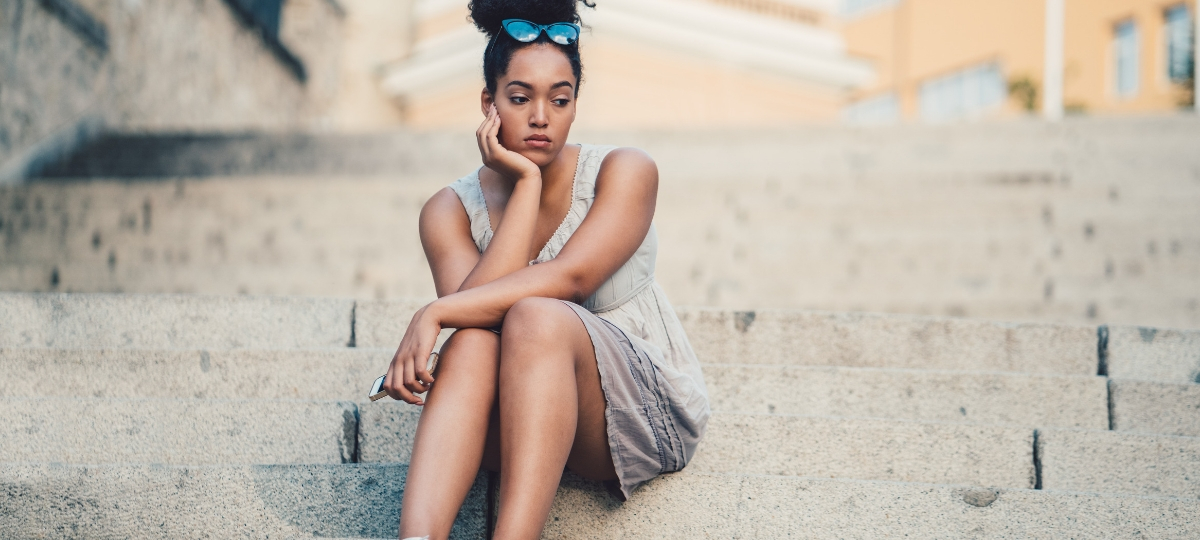 Après 23 ans, c'est plus difficile de se faire des amis Une femme assise seule sur un escalier