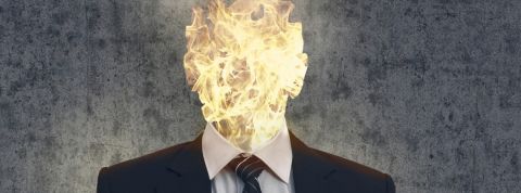 Qui profite de la souffrance au travail ?  Un homme en costume dont la tête est enflammée