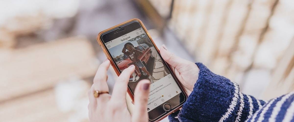 Facebook va multiplier les publicités sur Instagram Une femme regarde son film d'actualité Instagram sur son smartphone