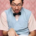 Homme geek consulte un dictionnaire.