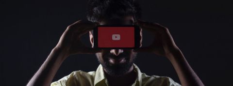 Les secrets des empires médiatiques de YouTube Un homme dissimulé derrière un smartphone sur YouTube
