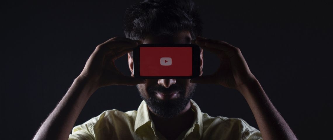 Les secrets des empires médiatiques de YouTube Un homme dissimulé derrière un smartphone sur YouTube