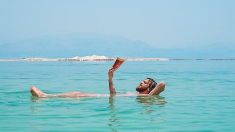 Homme à barbe lit dans l'eau.