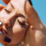 Une femme regarde son reflet dans un miroir brisé