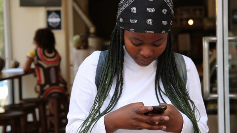 Jeune fille tape un message un message sur son téléphone.