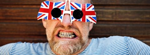 Décryptage des anglicismes au bureau Un homme en train de faire une grimace et portant des lunettes avec l'Union Jack