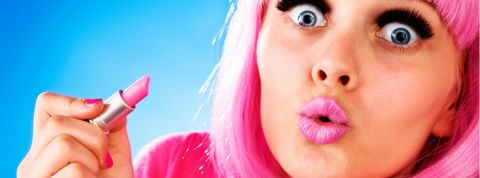 Peut-on faire de la pub responsable ? Une femme très maquillée portant une perruque rose et tenant un tube de rose à lèvres