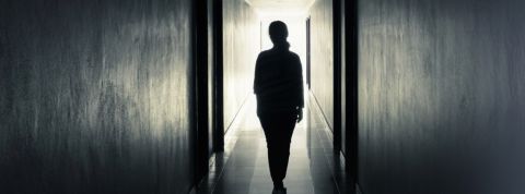 Les instagrameuses quittent le réseau uune femme de dos dans un couloir sombre