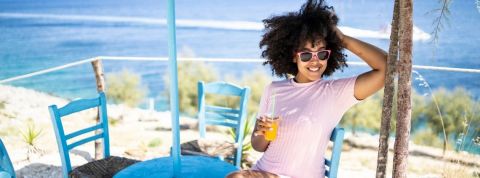 Découvrez la tendance du célibat positif Une femme seule et heureuse qui boit un jus d'orange