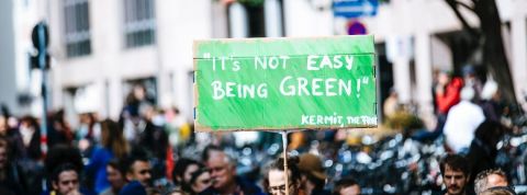 Total assigné en justice pour inaction climatique Une pancarte - it's not easy being green -