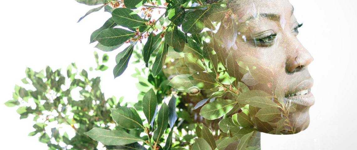 Quels sont les métiers qui recrutent en freelance en matière de développement durable ? Une femme noire dont le visage est mélangé à des plantes