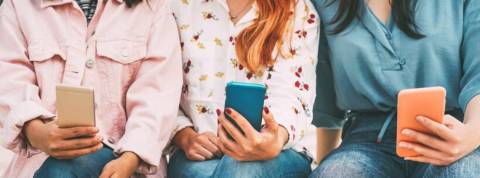 Comment mieux contrôler ses données facebook Trois femmes assises tiennent leur téléphone portable