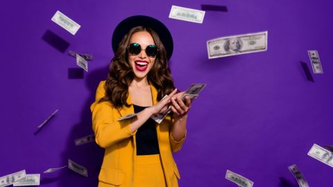 une femme habillé en jaune qui disperse des billets de banque