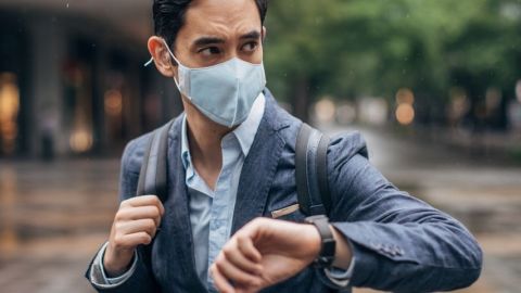 un homme en costume porte un masque