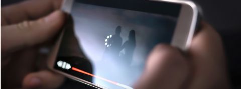 Pendant la période de confinement, les plateformes sont invitées à ne plus diffuser leurs contenus en haute définition Une personne en train de lire une vidéo dont le téléchargement est lent sur son smartphone