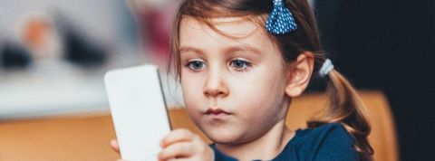 Éviter la surexpostion aux écrans pendant le confinement avec Anne-Lise Ducanda Une petite fille hypnotisée par un smartphone