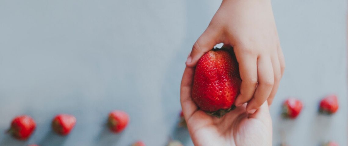 Comment les noms de marques et de produits peuvent influer sur notre perception ? Un enfant donne une fraise