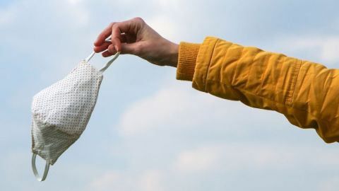 Un bras qui jette un masque