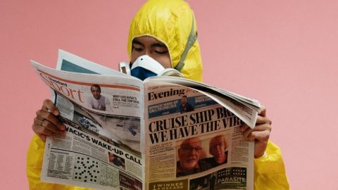 Un homme en combinaison anti-radiations en train de lire un journal