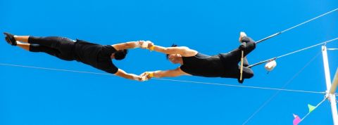 Comment devenir une HRO ? Deux trapézistes en train de faire des acrobaties
