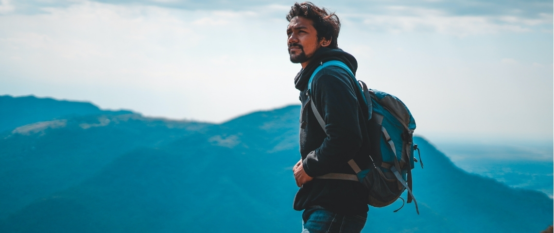 Comment Canada Goose incite ses salariés à faire de l'exercice Un homme sur une montagne avec un sac à dos