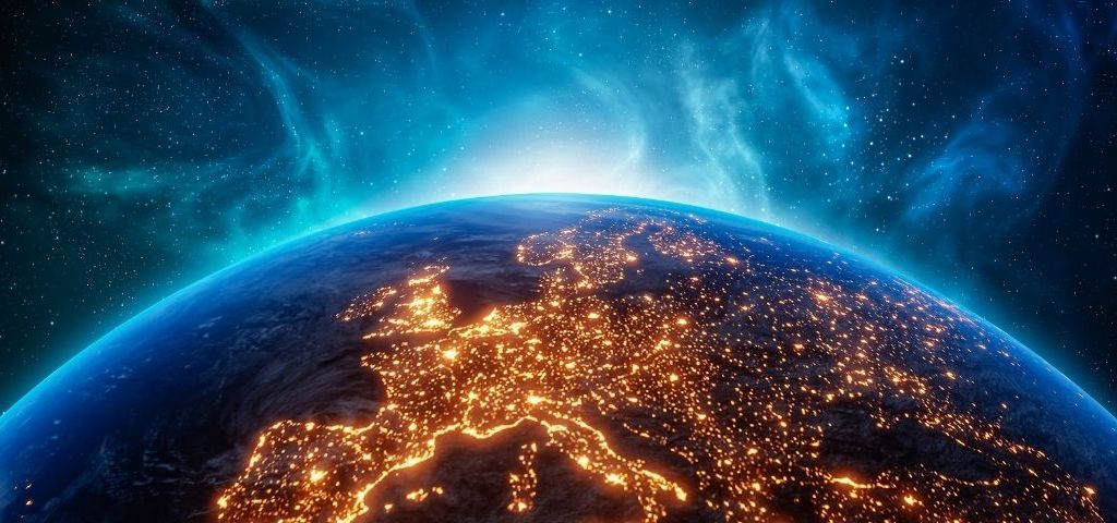 photographie de la terre vue du ciel avec des lumières qui scintillent