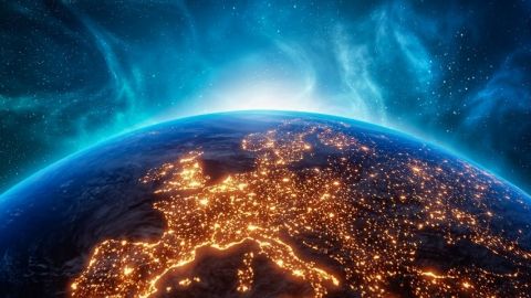 photographie de la terre vue du ciel avec des lumières qui scintillent