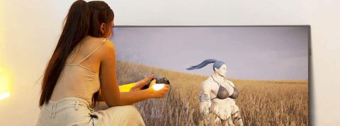 Pastoral-Hamouda Fille de dos dans la nature jouant à un jeu vidéo sur une grande TV