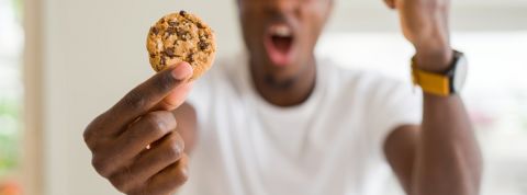 Des cookies ou des euros ? Sur certains sites, il faut désormais choisir Un homme énervé tenant un cookie dans sa main