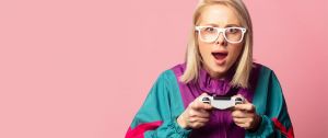Jeune fille blonde à lunettes et joystick dans les mains