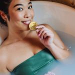 Fille dans son bain qui mange un bitcoin