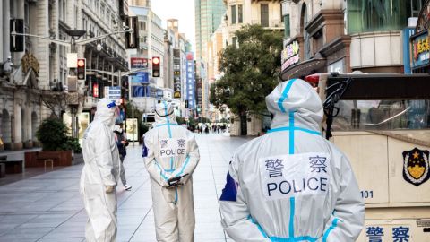 Shanghai-police Des hommes en blouses blanche dans les rues déserte d'une grande ville en Chine.