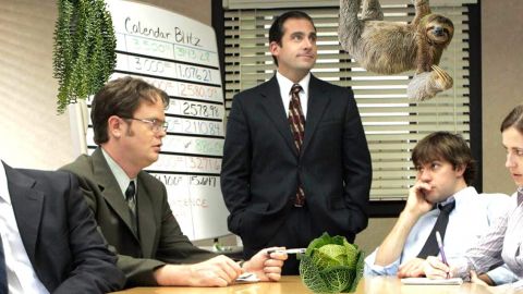Scène de la série The Office avec 5 personnes en réunion et girafe, paresseux, chou