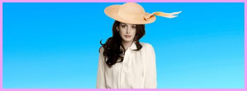C'est quoi le style coastal granny ? Sur fond bleu, l'actrice Anne Hathaway portant un chapeau en paille