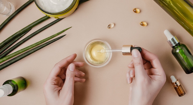 Woman cosmetologist cosmetics testing. Natural organic cosmetics. Serum hair mask. Flat lay pastel Woman cosmetologist cosmetics testing. Natural organic cosmetics. Serum hair mask. Flat lay pastel