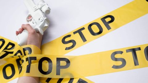 Arme à feu avec des rubans jaunes STOP