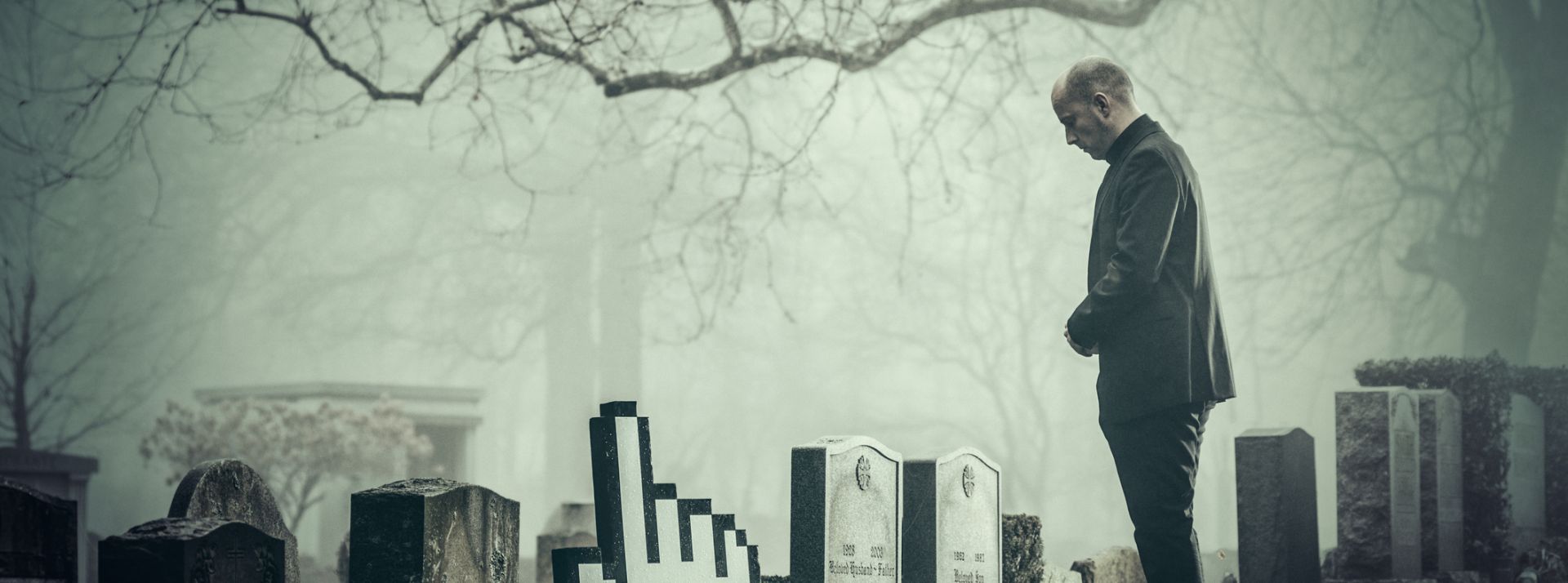 Technology life cycle Man in graveyard by gravestone in the shape of a hand cursor