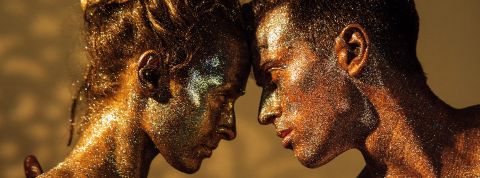 Couple face à face couvert de paillettes dans les tons or