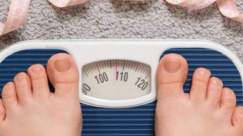 2 pieds sur une balance entourés par un mètre