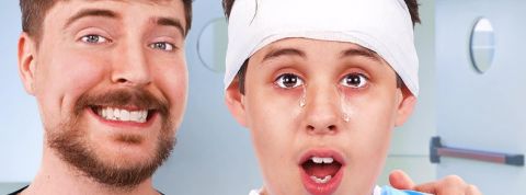 mr-Beast un jeune homme barbu tient par l'épaule un enfant qui recouvre la vue