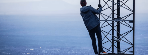 Scope et transition écologique Un homme accroché à une antenne